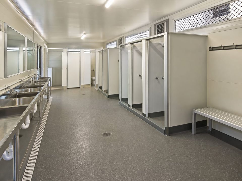 Prefab dormitory ablution area sized for peak shift-change demand