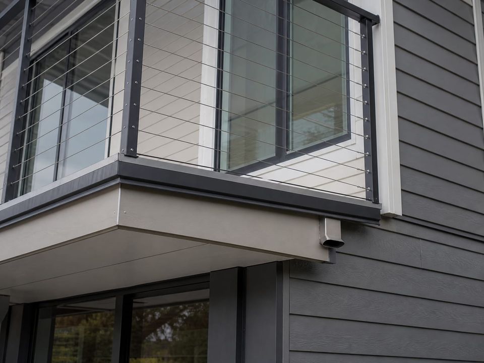 Two-storey steel home balcony with guarding, drainage, and thermal break at the junction