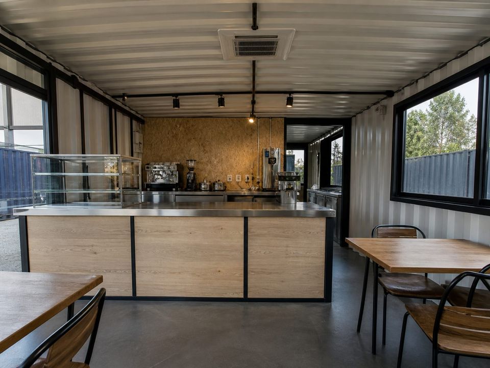 Custom container café interior with service counter, seating, and extraction