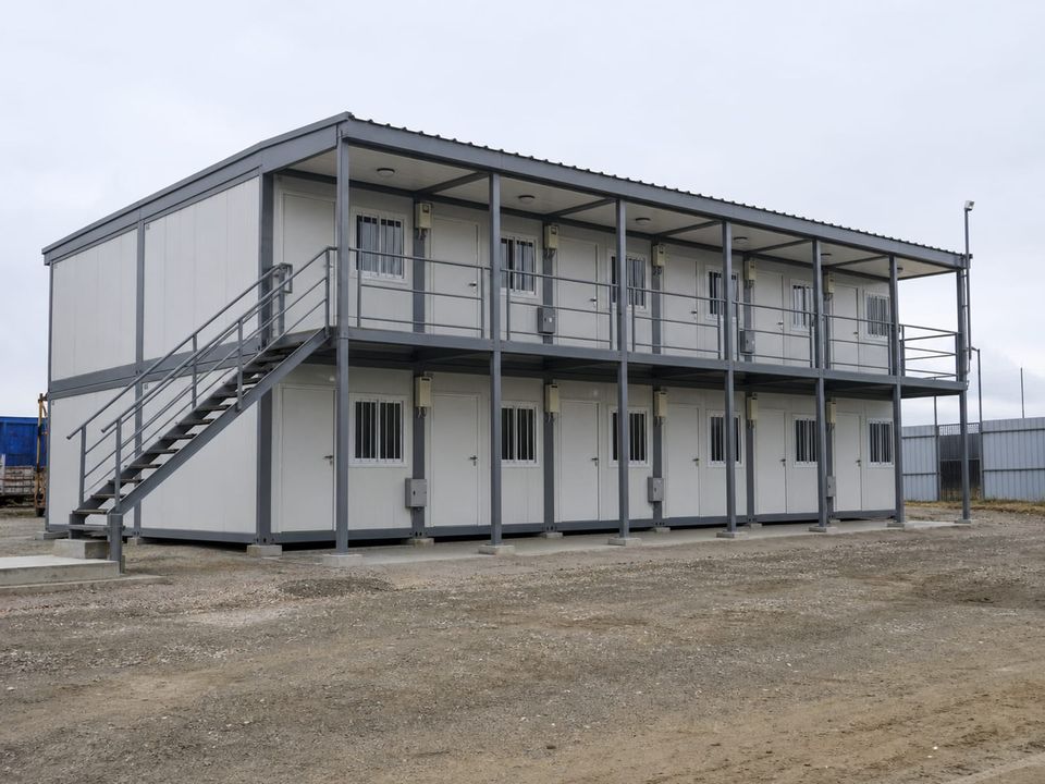 Multi-storey dormitory container camp block with external stairs and walkways