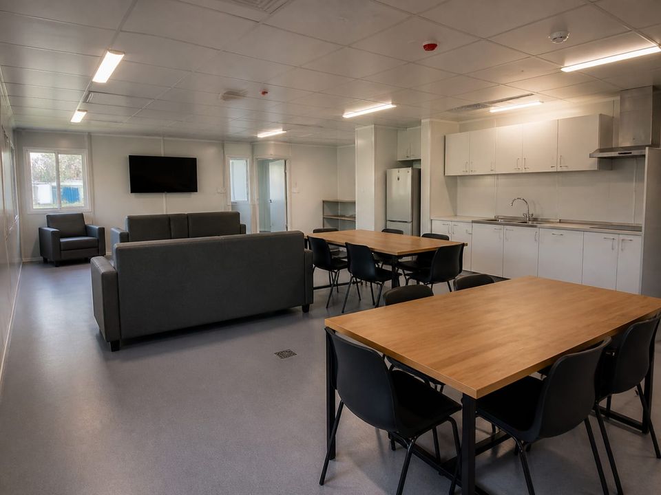 Prefab dormitory common room providing off-shift space away from sleeping areas