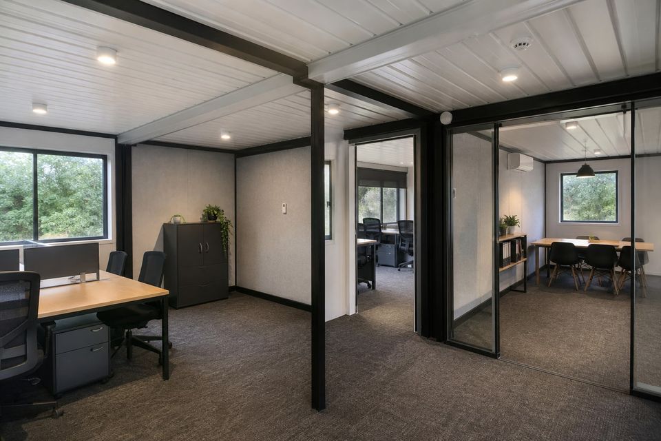 Contemporary modular container office interior with coordinated daylight and work areas