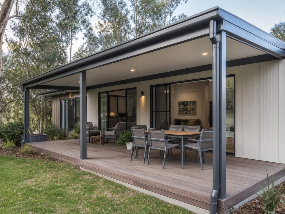 Single-storey steel home covered terrace with shading and external lighting