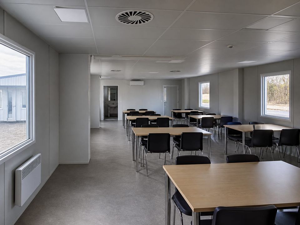 Cafeteria container dining area with table layout, circulation width, and ventilation