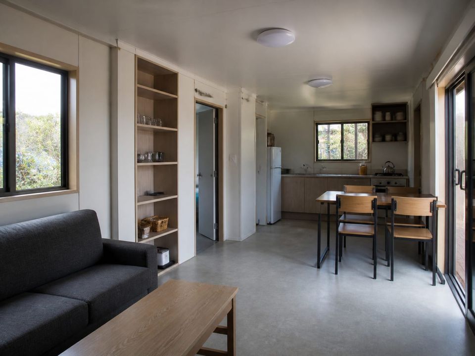 Affordable prefab dwelling interior with daylight, storage, and durable finishes