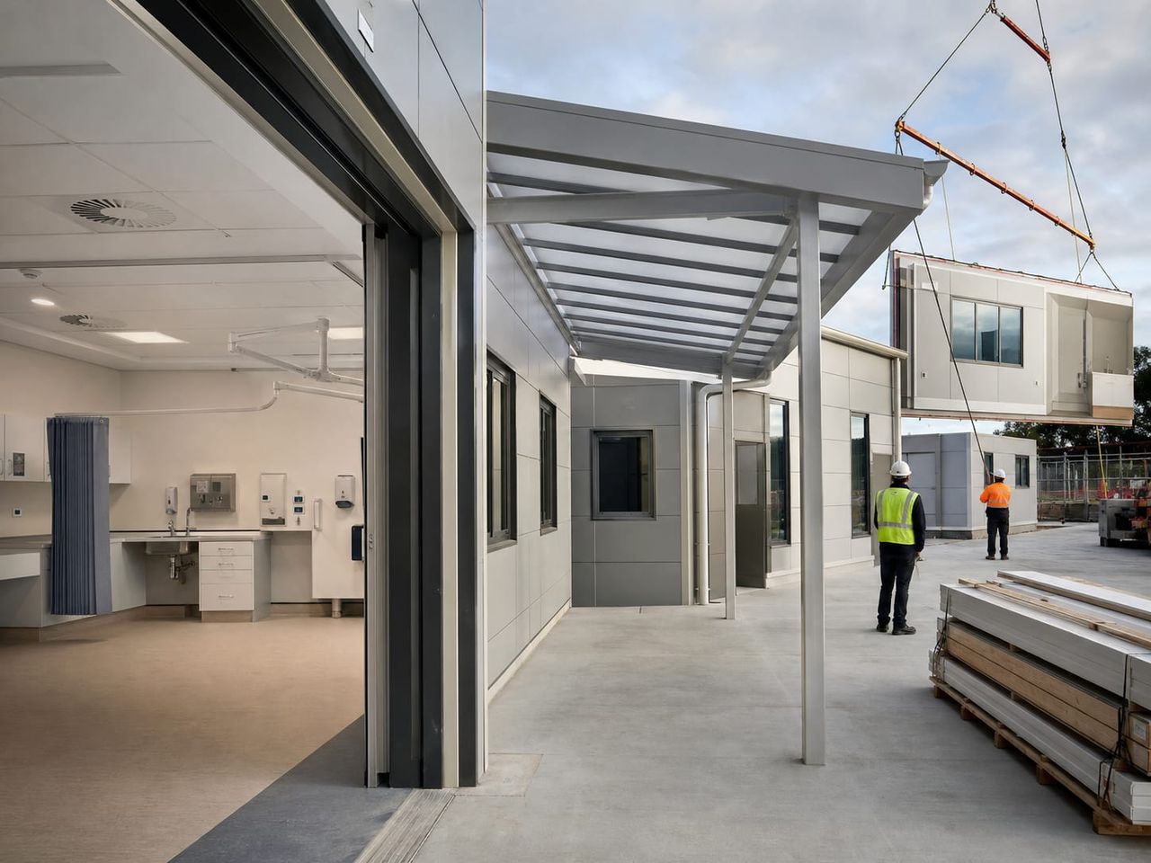 Prefab hospital building installation coordinated with foundations, protected services, emergency access, and external works