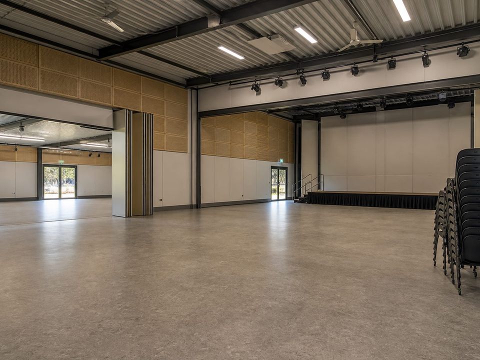 Flexible prefab social facility hall planned for community programs and changing seating layouts