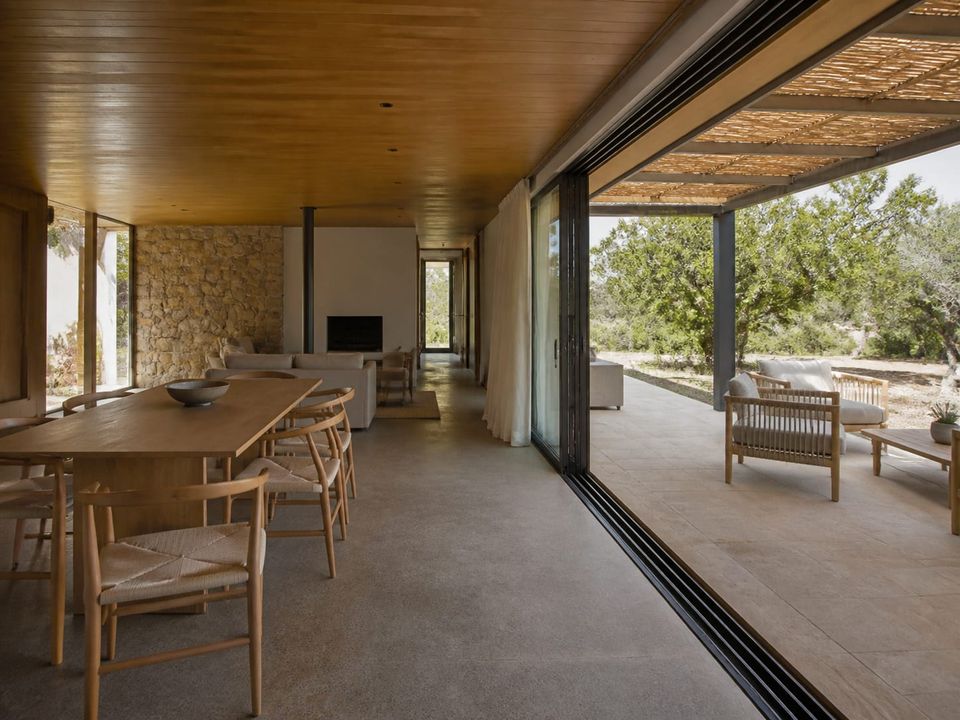 Prefab villa living space opening onto a shaded terrace with level threshold