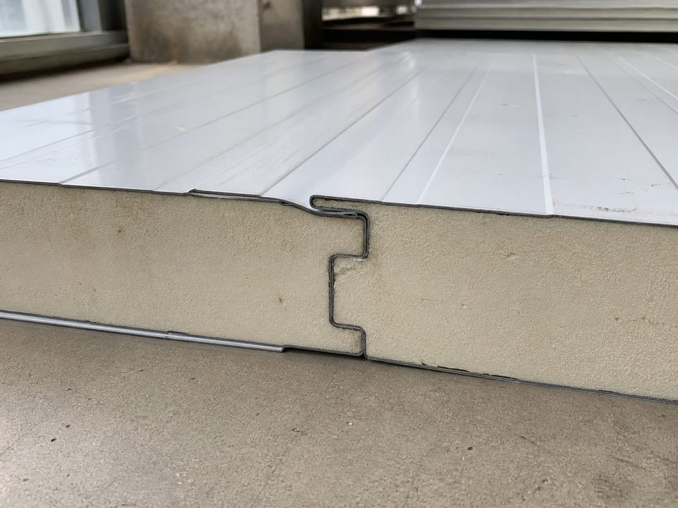 Sandwich panel detail showing core, facings, joint profile, and coating