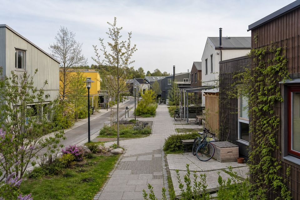 Walkable prefab housing neighborhood with varied homes, landscape, and community space