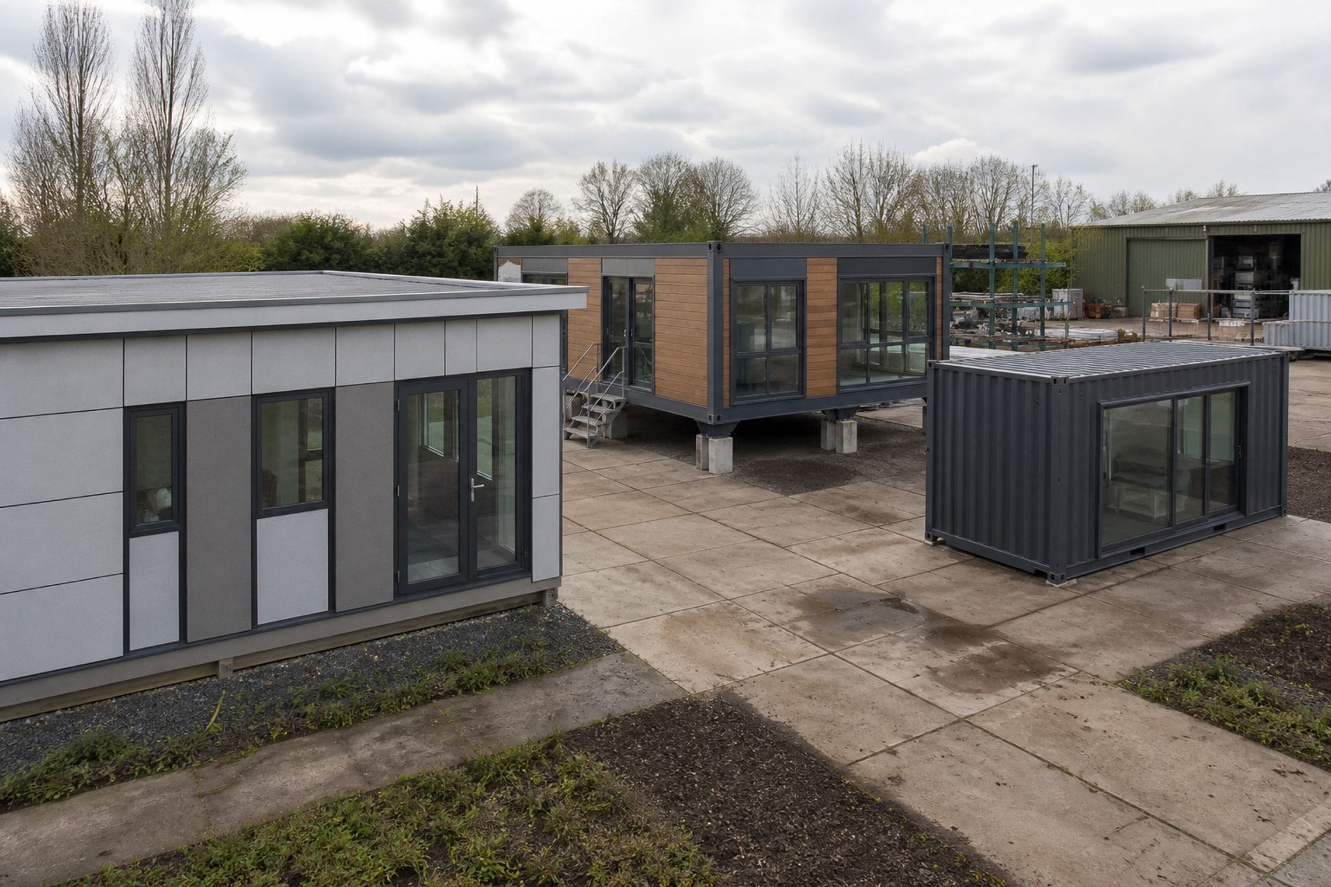 Three different offsite building systems arranged in a construction yard