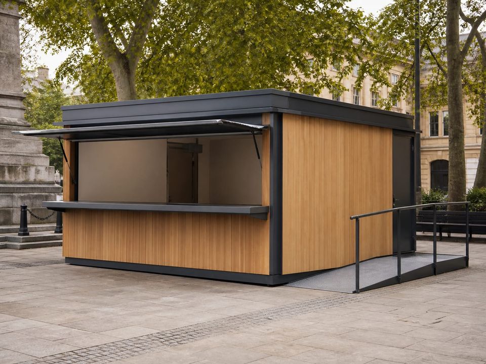 Metropol kiosk in a public square with serving hatch, canopy, and accessible approach