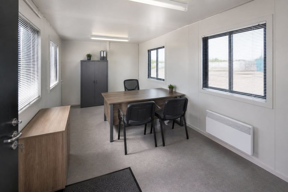 Spacious cabin used as a visitor reception with waiting area and staffed desk