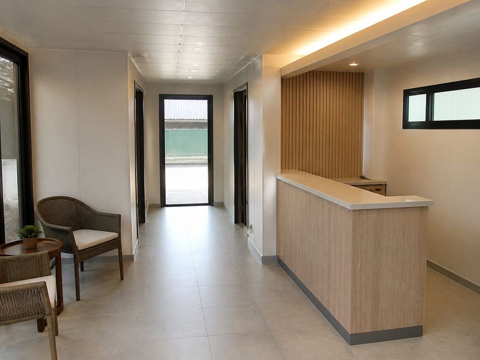 Prefab hotel reception and lobby arranged for arrival, check-in, luggage handling, and guest circulation