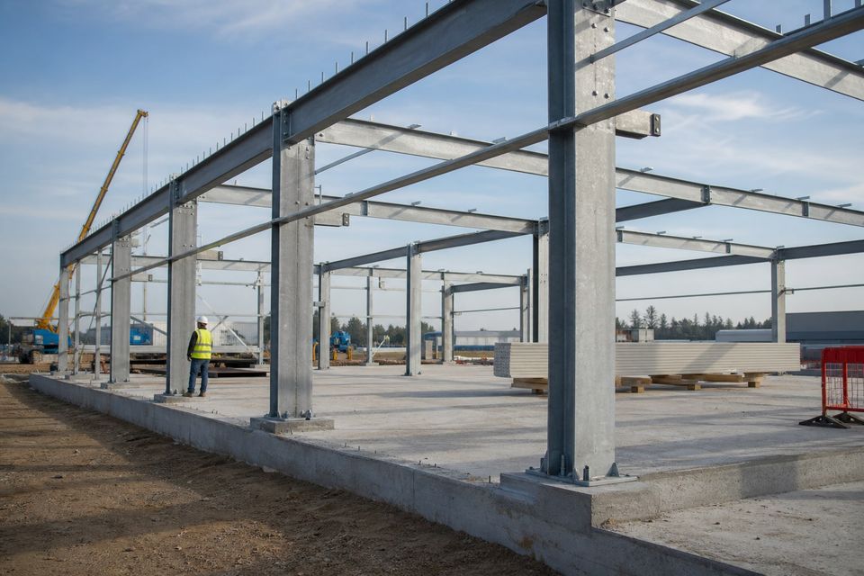 Engineered steel frame for a prefabricated commercial building during assembly