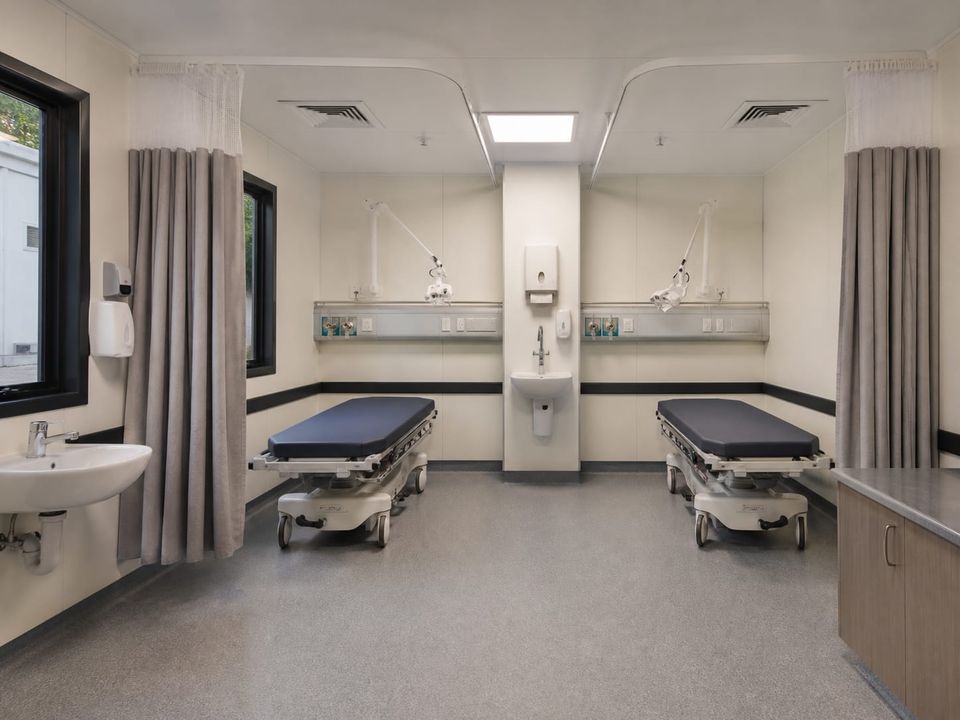 Prefab hospital treatment area arranged around safe clinical workflows, equipment, utilities, and observation