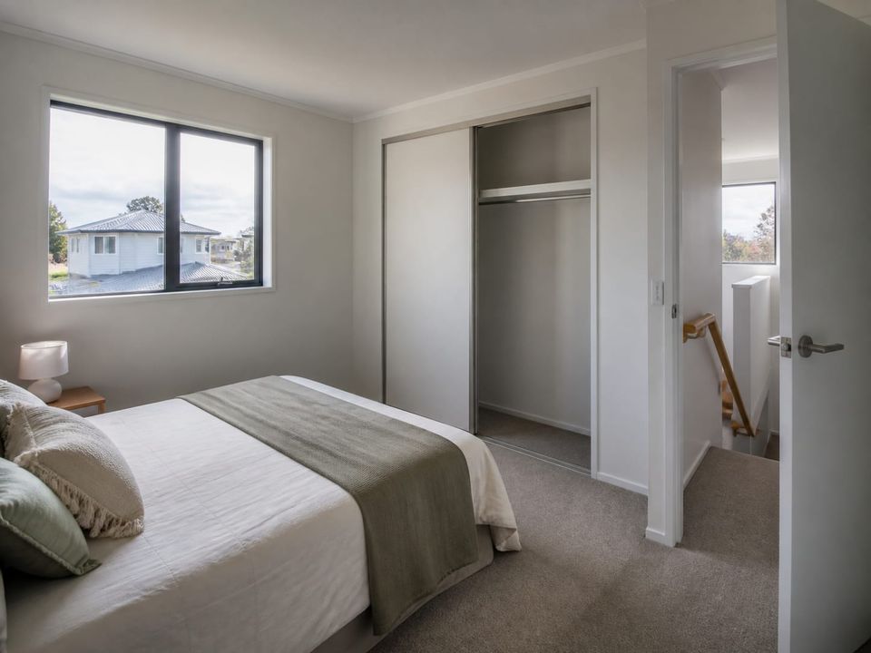 Upper floor bedrooms in a two-storey prefab home with wardrobe provision and daylight